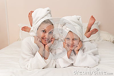 Daughter mom love smiling dries bath thinks elbows smile bathrobe, for portrait cute from woman from hotel beautiful Stock Photo