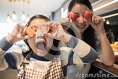 Daughter and mother preparing the sandwich and salad for breakfast in kitchen. Stock Photo