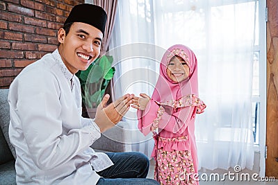 Daughter shake hands to his father apologize on eid mubarak Stock Photo