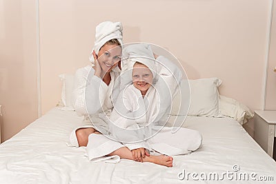 Daughter smiling mom love dries bath thinks elbows Creek bathrobe, for girl cute for lifestyle and shower beautiful Stock Photo