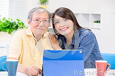 Daughter teach father use tablet Stock Photo
