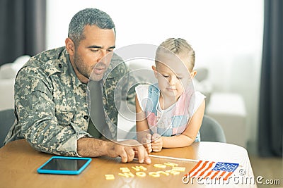 Daughter welcoming father serving in armed forces at home Stock Photo