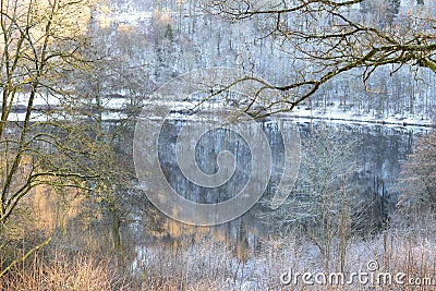 GemÃ¼ndener Maar in winter, mystic athmosphere with reflections on the calm water Stock Photo