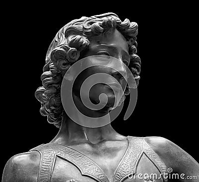 David killer of Goliath ancient statue. Biblical story. Antique sculpture of young man in armor isolated on black Stock Photo