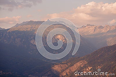 Dawn Alps mountains France, snowy peaks in fog, summer sunset Stock Photo