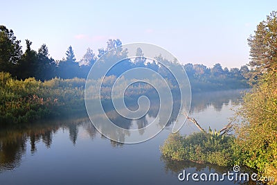 Dawn on the bank of a winding river Stock Photo