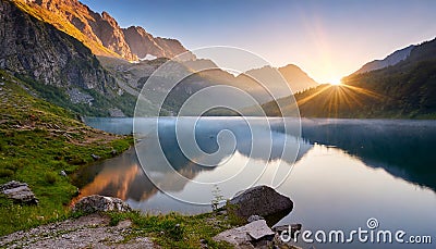 A dawn breeze ruffled the surface of the breathtaking lake. Stock Photo