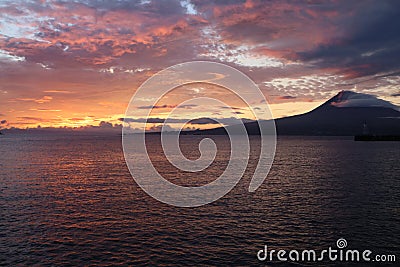The dawn lights illuminate the island of Pico and its volcano, Pico island, Azores Stock Photo