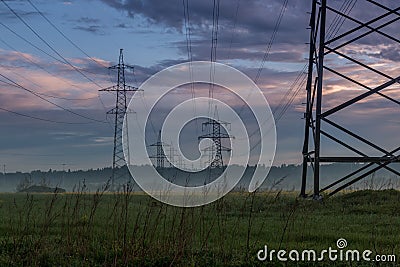 Dawn. Power lines in the fog. Sky Stock Photo