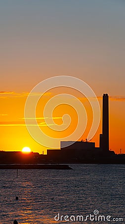 Dawn at power plant. UHD vertical wallpaper Stock Photo