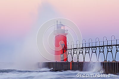 Dawn, South Haven Lighthouse with Crashing Wave Stock Photo