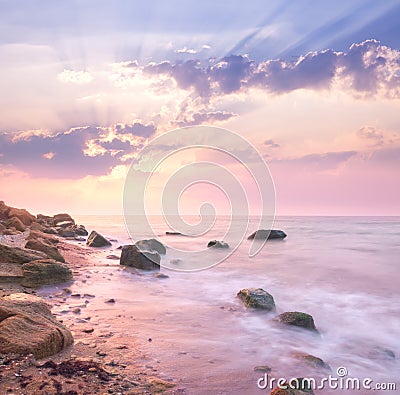 Dawn sunrise landscape over beautiful rocky coastline in the Sea Stock Photo