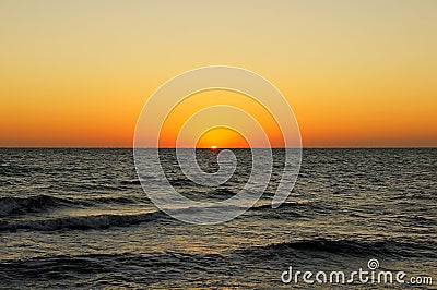 Dawn and sunset at sea and ocean. sunrise in the morning on the shore. the sun rises above the horizon. warm summer evening Stock Photo