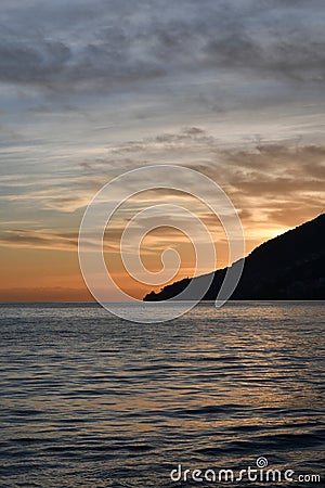 The sunset over a town on the Campania coast on the road to Amalfi. Stock Photo
