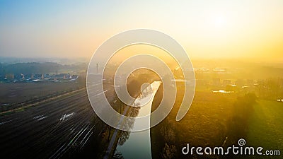 Dawn's First Light Over Serene Canal and Railway in Countryside Stock Photo