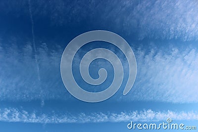 Pretty blue skies after dawn with white puffy clouds opening up for the sunny day ahead Stock Photo