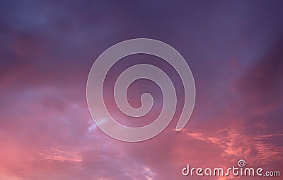 Pretty red and purple skies at daybreak, with large puffy clouds opening up for the sunny day ahead Stock Photo