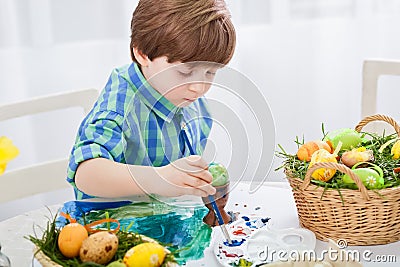 The day before Easter, beautiful child painting eggs for easter Stock Photo