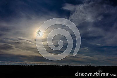 A wonderful full moon has descended over Ukrainian carpathians in blurry clouds Stock Photo