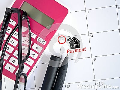 Day of payment for rent or loan. Calendar,pen, calculator,glasses and icon home with text paymen Stock Photo