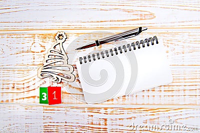 Day 31th of month, calendar on white background with wooden christmas tree, pen and notebook. Stock Photo