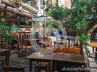 Day view of the empty traditional outdoor seating area of taverns with colorful chairs, tables and vintage decoration Editorial Stock Photo