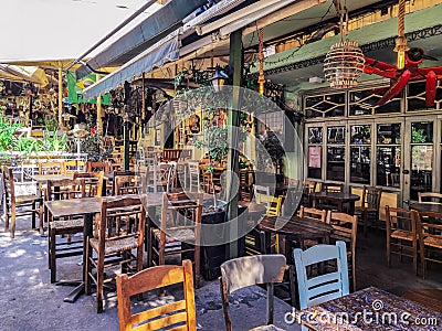 Day view of the empty traditional outdoor seating area of taverns with colorful chairs, tables and vintage decoration Editorial Stock Photo