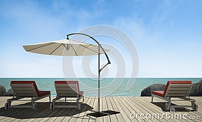 Daybed with umbrella on wooden terrace at sea view Stock Photo