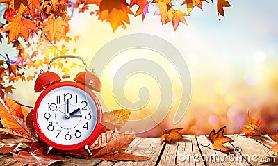 Daylight Savings Time Concept - Clock And Leaves Stock Photo