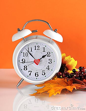 Daylight savings time ends in autumn fall with clock Stock Photo