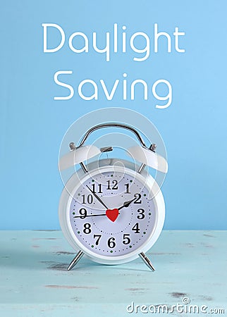 Daylight savings time white clock on a vintage aqua blue wood table Stock Photo