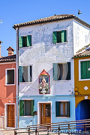 Daylight view to colorful old building with painting falling off Editorial Stock Photo