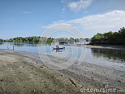 daytime fishing boat sailing at the distance with unrecognizable fishermen. Stock Photo