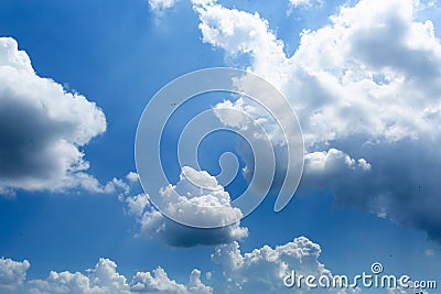 Daytime sky with cumulus clouds. small birds high in the sky Stock Photo