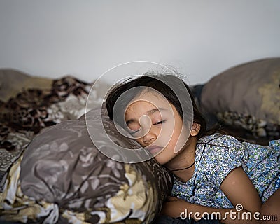 Daytime sleeping time of a toddler child. Little girl sleeping on the bed Stock Photo