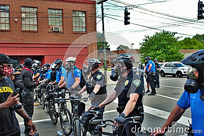 Dayton, Ohio United States 05/30/2020 police officers putting on gas masks preparing to deploy OC pepper spray and tear gas at a Editorial Stock Photo