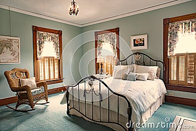 Iron Bed in Teal Bedroom od Old Victorian Home Editorial Stock Photo