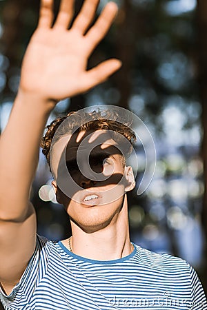 Dazzled sunlight handsome man nature concept. Stock Photo