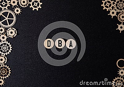 DBA text assembled from wooden cubes on a black background Stock Photo