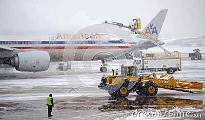 De-icing Aircraft during a snow storm Editorial Stock Photo