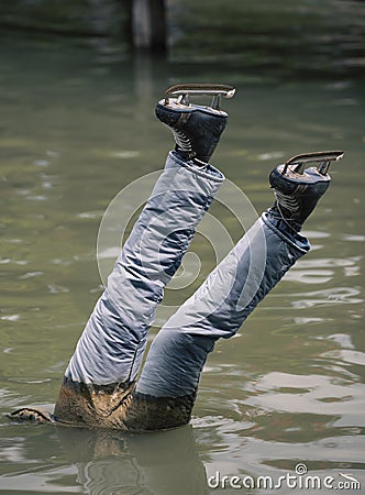Dead ice skater head downwards in water Stock Photo