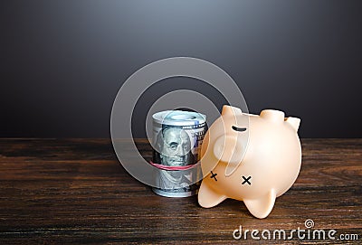 Dead pig piggy bank with money. Financial crisis, depletion of savings and bankruptcy. Default, non-payment of obligations. Stock Photo