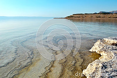 The Dead Sea, a coast created by salt, forms layers of salt at the bottom. Fascinating natural phenomenon in Jordan Stock Photo