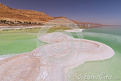 Dead Sea coastline with white salt and mountains in Ein Bokek, Israel Stock Photo