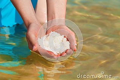 Dead Sea salt in hands Stock Photo