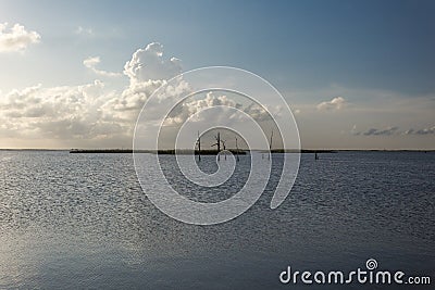 Dead trees in middle of Yellow Cotton Bay deep in southern Louisiana on sunny day with thick clouds Stock Photo