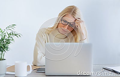 Deadline stress concept. Tired businesswoman looking at laptop Stock Photo