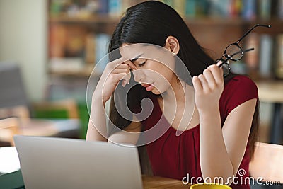 Deadline stress. Exhausted asian girl freelancer tired after work on laptop Stock Photo