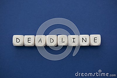 Deadline word on wood blocks over blue background with copy space Stock Photo