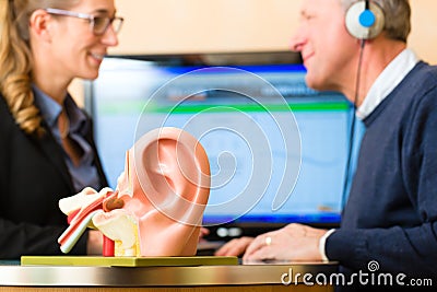 Deaf man makes a hearing test Stock Photo